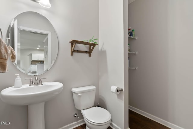 8005 Caithness St, Raleigh, NC 27616 - bathroom with toilet and wood finished floors