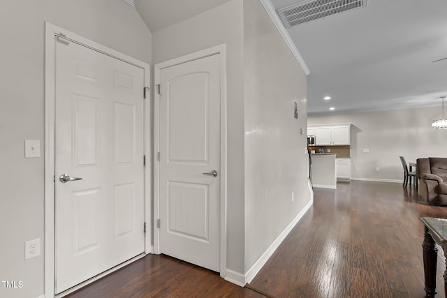 8005 Caithness St, Raleigh, NC 27616 - hallway featuring dark wood finished floors, recessed lighting, a chandelier, and ornamental molding