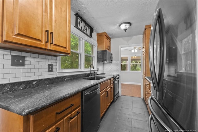 1905 Mcgougan Rd, Fayetteville, NC 28303 - kitchen with freestanding refrigerator, dishwasher, black microwave, brown cabinetry, and range with electric cooktop