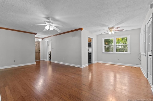 1905 Mcgougan Rd, Fayetteville, NC 28303 - unfurnished living room featuring ceiling fan, a textured ceiling, wood finished floors, and ornamental molding