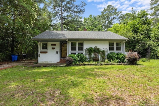 1905 Mcgougan Rd, Fayetteville, NC 28303 - view of front of house with a front lawn and a chimney
