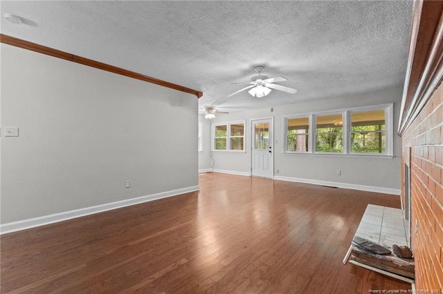 1905 Mcgougan Rd, Fayetteville, NC 28303 - unfurnished living room with ceiling fan, a textured ceiling, wood finished floors, and ornamental molding