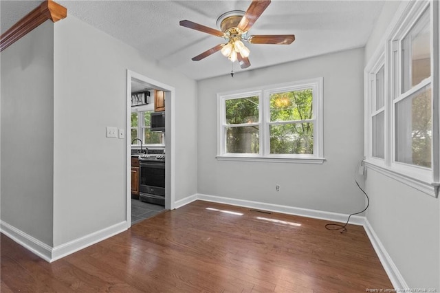 1905 Mcgougan Rd, Fayetteville, NC 28303 - spare room with ceiling fan and dark wood-style flooring