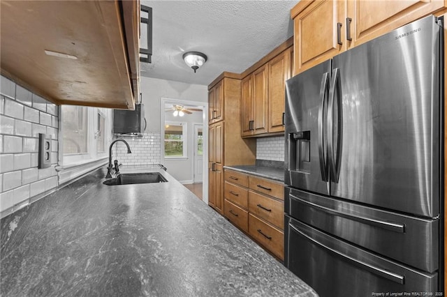 1905 Mcgougan Rd, Fayetteville, NC 28303 - kitchen featuring fridge with ice dispenser, dark countertops, backsplash, brown cabinetry, and ceiling fan