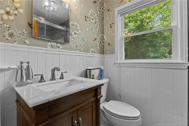 1905 Mcgougan Rd, Fayetteville, NC 28303 - bathroom with vanity, wallpapered walls, tile walls, and wainscoting