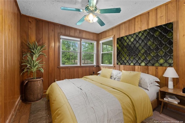 1905 Mcgougan Rd, Fayetteville, NC 28303 - bedroom with a textured ceiling, wood walls, and a ceiling fan