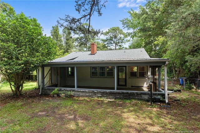 1905 Mcgougan Rd, Fayetteville, NC 28303 - back of property featuring a chimney and a sunroom