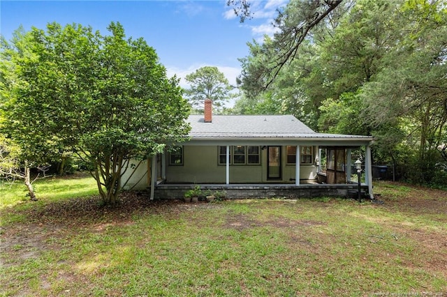 1905 Mcgougan Rd, Fayetteville, NC 28303 - view of front facade with a front lawn and a chimney
