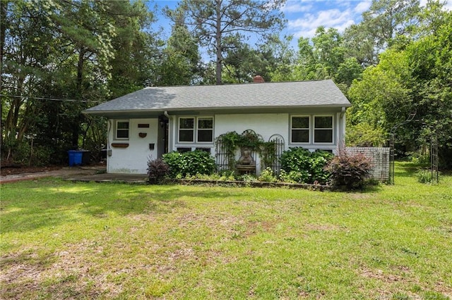 1905 Mcgougan Rd, Fayetteville, NC 28303 - view of front facade featuring a front yard, a chimney, and view of wooded area