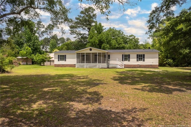 2990 Aberdeen Rd, Raeford, NC 28376 - rear view of house with a sunroom, crawl space, and a lawn