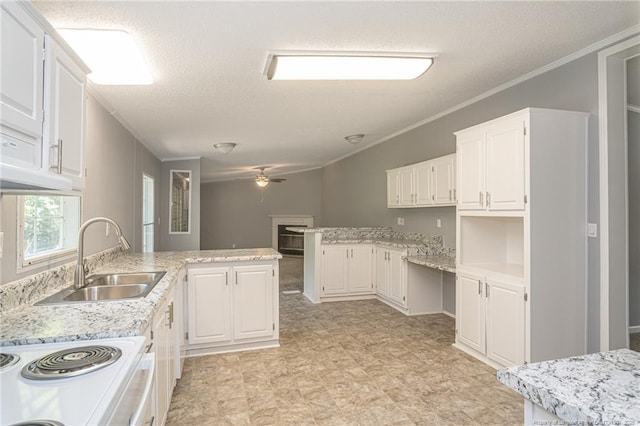 2990 Aberdeen Rd, Raeford, NC 28376 - kitchen with a peninsula, ceiling fan, a textured ceiling, crown molding, and white cabinetry