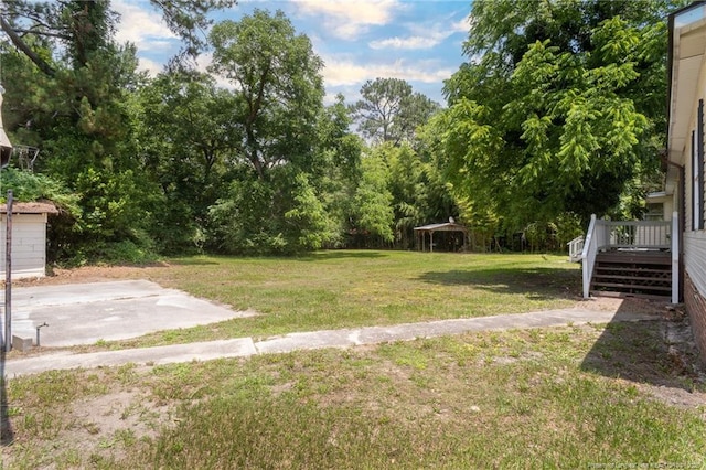 2990 Aberdeen Rd, Raeford, NC 28376 - view of green lawn with a wooden deck