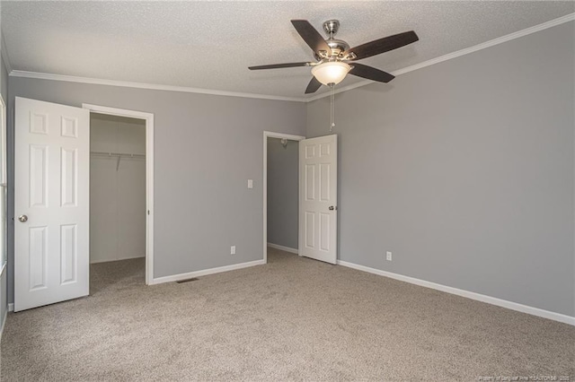 2990 Aberdeen Rd, Raeford, NC 28376 - unfurnished bedroom featuring a textured ceiling, ornamental molding, carpet floors, a closet, and ceiling fan