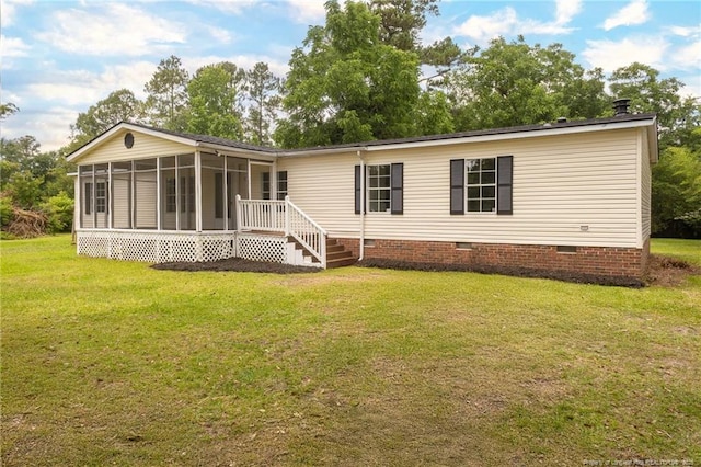 2990 Aberdeen Rd, Raeford, NC 28376 - rear view of house featuring crawl space, a sunroom, and a lawn