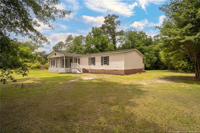 2990 Aberdeen Rd, Raeford, NC 28376 - back of house with a sunroom, crawl space, and a lawn