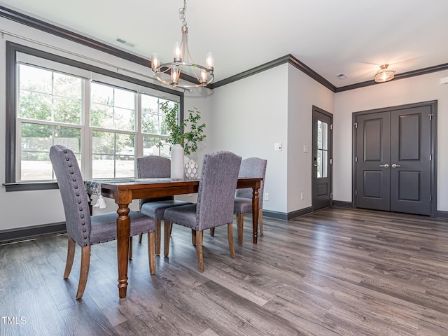 335 Glenn St, Franklinton, NC 27525 - dining space with a chandelier, healthy amount of natural light, dark wood-style floors, and crown molding