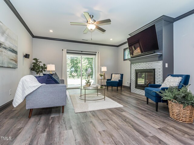 335 Glenn St, Franklinton, NC 27525 - living room featuring ornamental molding, a brick fireplace, wood finished floors, a ceiling fan, and recessed lighting