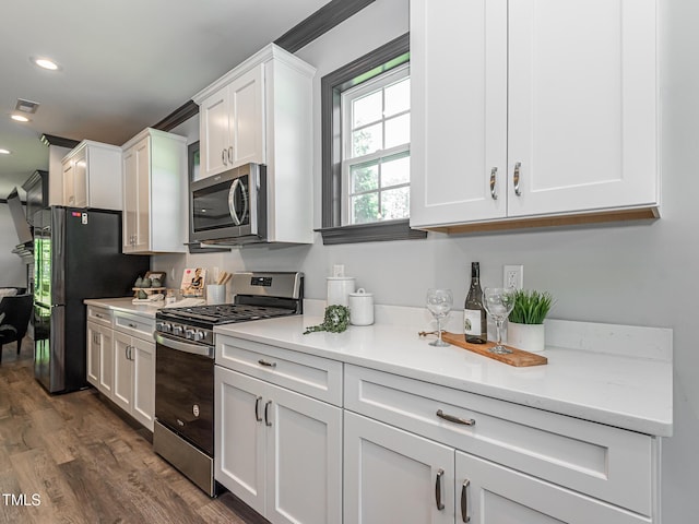 335 Glenn St, Franklinton, NC 27525 - kitchen with stainless steel appliances, white cabinets, light countertops, dark wood-style flooring, and recessed lighting