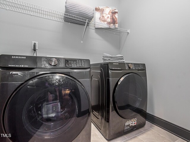 335 Glenn St, Franklinton, NC 27525 - laundry area with washer and dryer and tile patterned floors