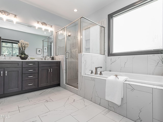 335 Glenn St, Franklinton, NC 27525 - full bath featuring marble look tiles, a bath, double vanity, a marble finish shower, and recessed lighting