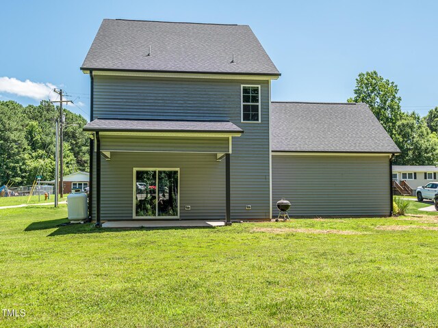 335 Glenn St, Franklinton, NC 27525 - rear view of house with a lawn, a patio area, and roof with shingles