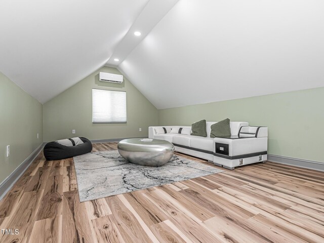 335 Glenn St, Franklinton, NC 27525 - living room with wood finished floors, vaulted ceiling, recessed lighting, and a wall unit AC