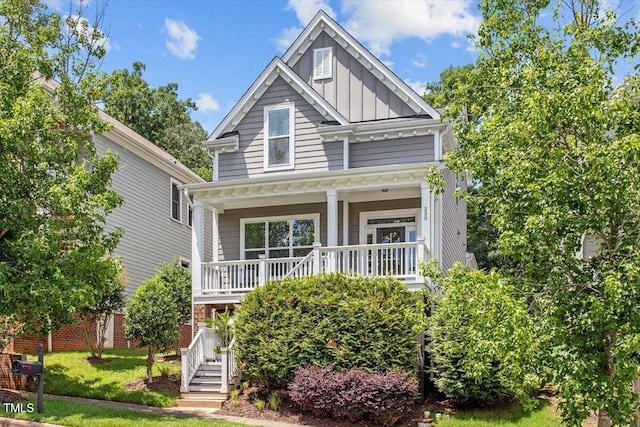 220 W Winmore Ave, Chapel Hill, NC 27516 - view of front facade featuring a porch, board and batten siding, stairway, and a front yard