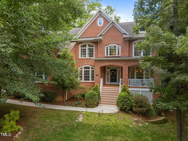 100 Redfoot Run Rd, Chapel Hill, NC 27516 - colonial house featuring brick siding, stairway, and a front lawn