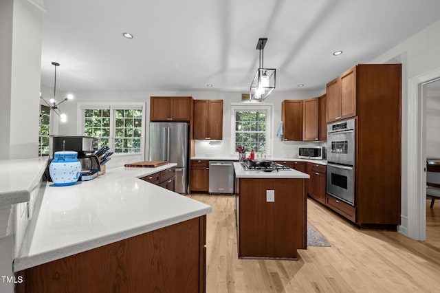 100 Redfoot Run Rd, Chapel Hill, NC 27516 - kitchen with appliances with stainless steel finishes, a center island, light wood-style flooring, light countertops, and recessed lighting