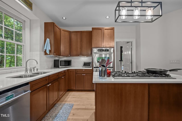 100 Redfoot Run Rd, Chapel Hill, NC 27516 - kitchen with stainless steel appliances, light countertops, brown cabinetry, decorative backsplash, and recessed lighting