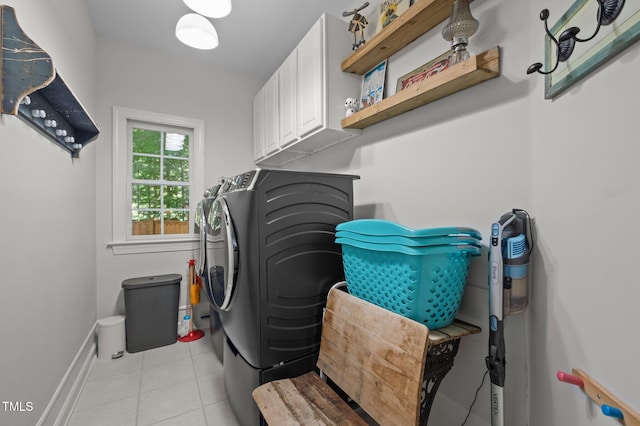 100 Redfoot Run Rd, Chapel Hill, NC 27516 - washroom featuring washing machine and clothes dryer, cabinet space, and light tile patterned flooring