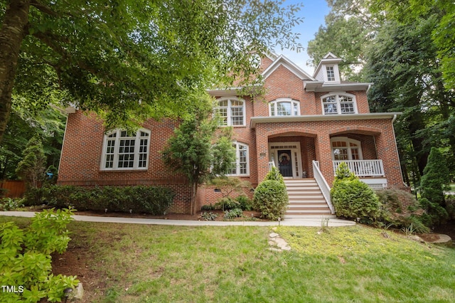 100 Redfoot Run Rd, Chapel Hill, NC 27516 - colonial home with a front yard, brick siding, stairway, and a porch