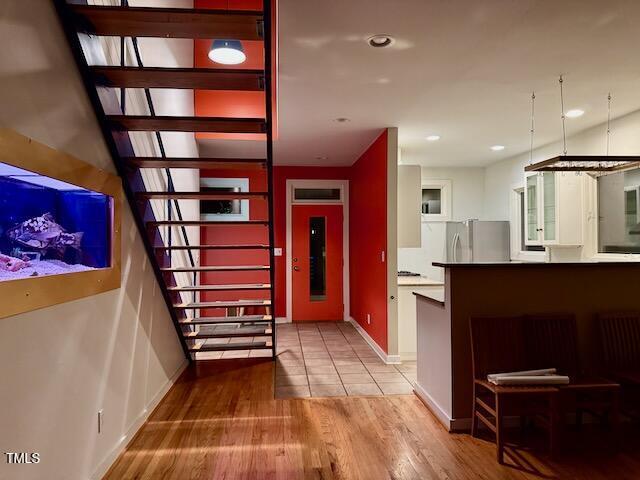 820 Runnymede Rd, Raleigh, NC 27607 - stairway with wood finished floors and recessed lighting