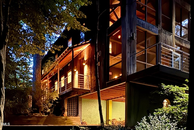 820 Runnymede Rd, Raleigh, NC 27607 - view of side of home featuring brick siding and a sunroom