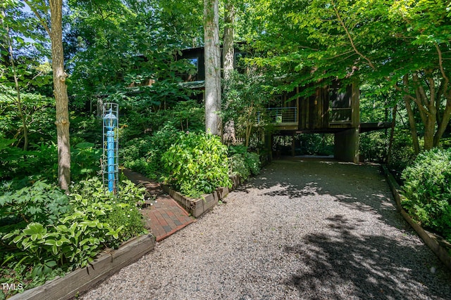 820 Runnymede Rd, Raleigh, NC 27607 - view of yard featuring gravel driveway, a vegetable garden, and a carport