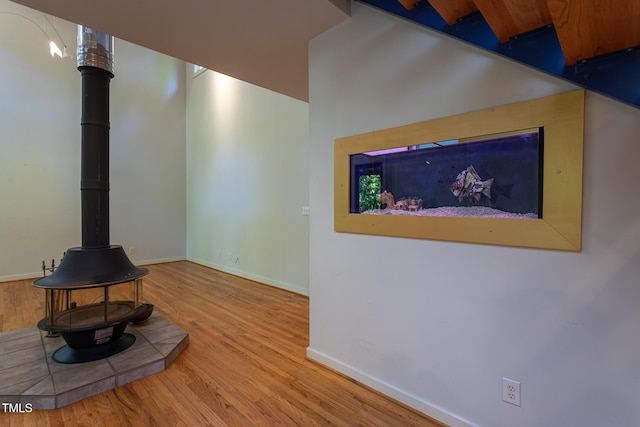 820 Runnymede Rd, Raleigh, NC 27607 - unfurnished living room with a wood stove and wood finished floors