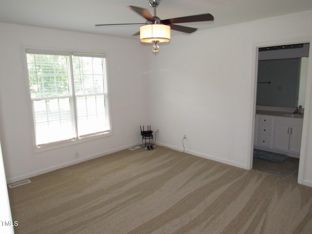 2662 Walas Ct, Creedmoor, NC 27522 - unfurnished bedroom with light carpet, connected bathroom, and a ceiling fan