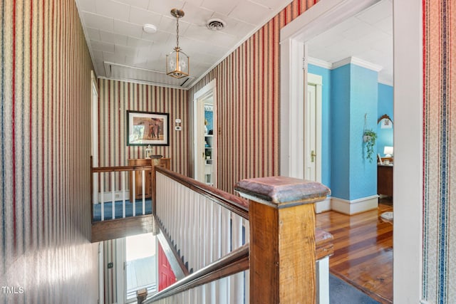 210 Peachtree St, Roxboro, NC 27573 - corridor with an upstairs landing, wood finished floors, wallpapered walls, and crown molding