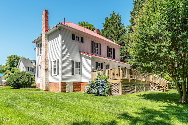 210 Peachtree St, Roxboro, NC 27573 - back of house with a chimney, a deck, and a lawn
