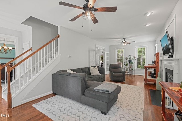 2925 Dargan Hills Dr, Wake Forest, NC 27587 - living area with wood finished floors, ceiling fan, stairs, and a glass covered fireplace
