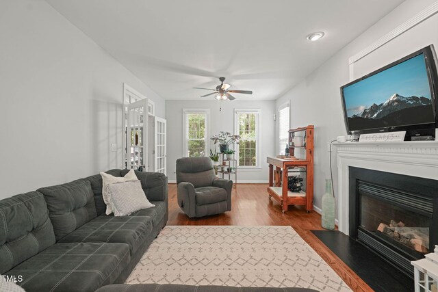 2925 Dargan Hills Dr, Wake Forest, NC 27587 - living room with dark wood-style floors, a ceiling fan, a fireplace with flush hearth, and recessed lighting