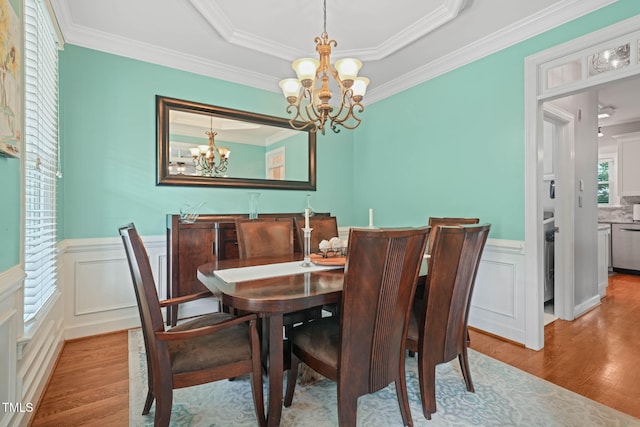 2925 Dargan Hills Dr, Wake Forest, NC 27587 - dining space featuring a chandelier, wood finished floors, crown molding, and wainscoting