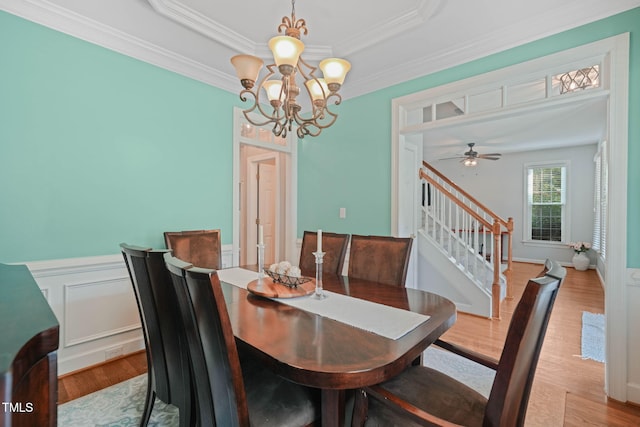 2925 Dargan Hills Dr, Wake Forest, NC 27587 - dining area with stairs, wood finished floors, a chandelier, ornamental molding, and wainscoting