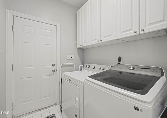 2925 Dargan Hills Dr, Wake Forest, NC 27587 - washroom with cabinet space, washer and clothes dryer, and light tile patterned flooring