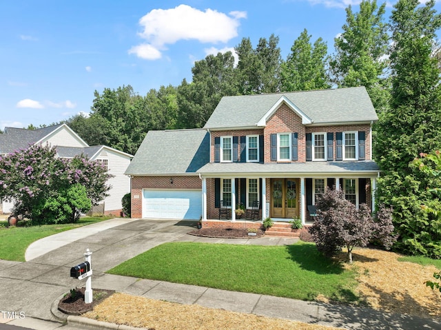 2925 Dargan Hills Dr, Wake Forest, NC 27587 - colonial inspired home with brick siding, covered porch, driveway, a front lawn, and a garage