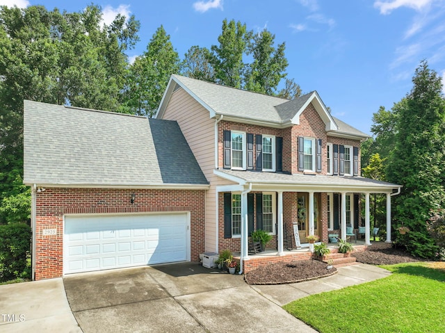 2925 Dargan Hills Dr, Wake Forest, NC 27587 - view of front of home featuring covered porch, brick siding, concrete driveway, a garage, and a shingled roof