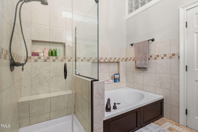 6205 Houndsman Ct, Raleigh, NC 27616 - full bath with a stall shower, a garden tub, and tile walls