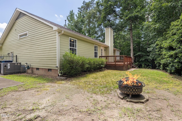 6205 Houndsman Ct, Raleigh, NC 27616 - view of side of home featuring a fire pit, a deck, crawl space, and a chimney