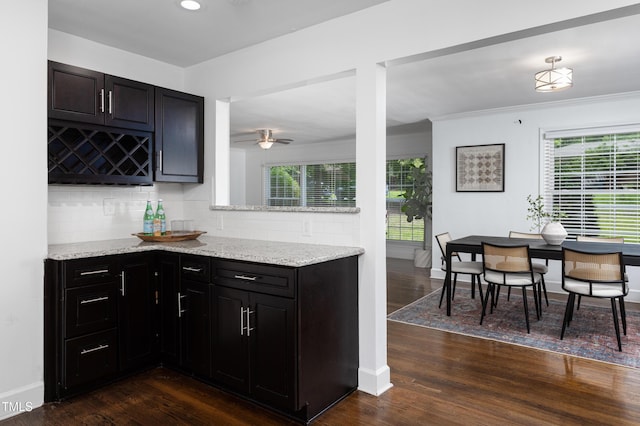 2801 E Shoreham St, Durham, NC 27707 - kitchen featuring decorative backsplash, healthy amount of natural light, light stone counters, crown molding, and recessed lighting