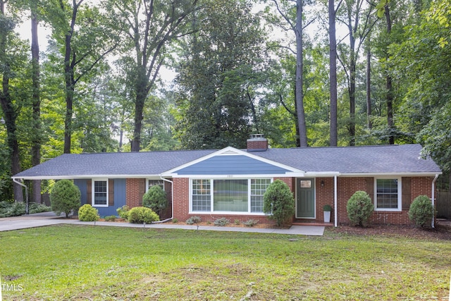 2801 E Shoreham St, Durham, NC 27707 - single story home featuring brick siding, driveway, a chimney, and a front yard